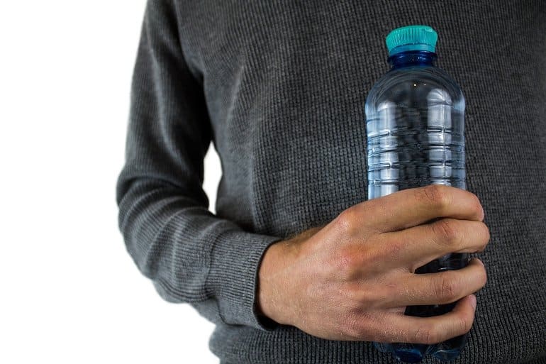 This shows a man holding a water bottle